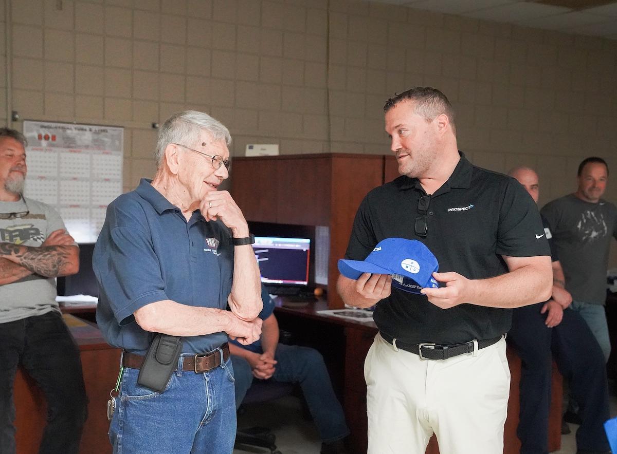 During his retirement celebration, Bill Null received an honorary company hat from Prospect Mold President Brandon Wenzlik. Jeremy Brown/The Portager